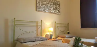 Letto o letti in una camera di La Solidea - Villa con giardino a pochi passi da Cala Ginepro