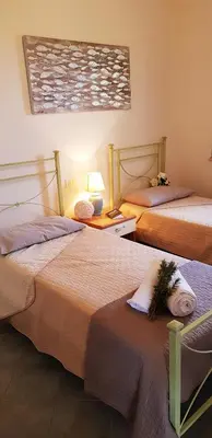 Letto o letti in una camera di La Solidea - Villa con giardino a pochi passi da Cala Ginepro