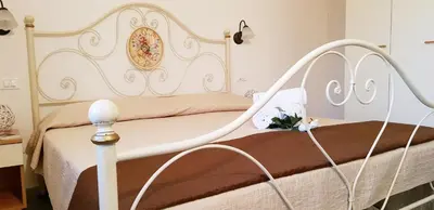 Letto o letti in una camera di La Solidea - Villa con giardino a pochi passi da Cala Ginepro