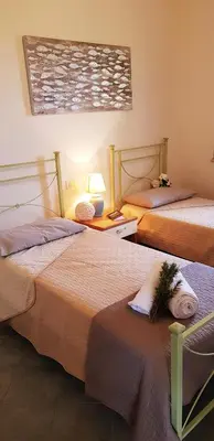 Letto o letti in una camera di La Solidea - Villa con giardino a pochi passi da Cala Ginepro