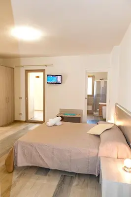Letto o letti in una camera di MOLAROTTO CAMERE CON ANGOLO COTTURA