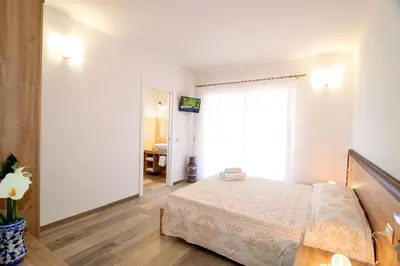 Letto o letti in una camera di MOLAROTTO CAMERE CON ANGOLO COTTURA