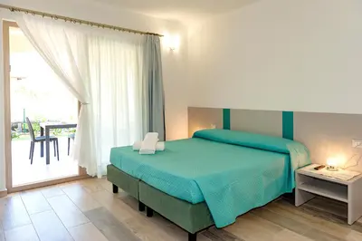 Letto o letti in una camera di MOLAROTTO CAMERE CON ANGOLO COTTURA