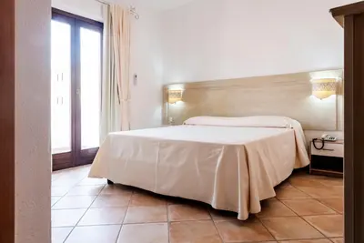Letto o letti in una camera di Hotel il Faro di Molara