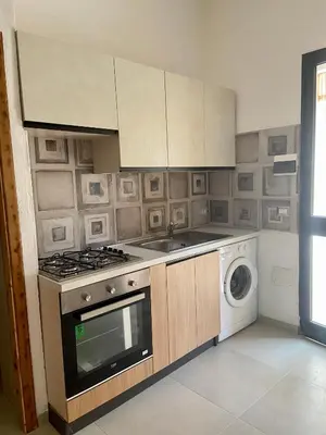 Cucina o angolo cottura di Giardino privato & BBQ Relax a La Caletta per 4