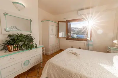 Letto o letti in una camera di Perseo case vacanze Poggio dei fiori con piscina privata