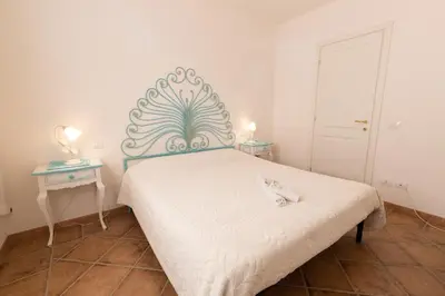 Letto o letti in una camera di Perseo case vacanze Poggio dei fiori con piscina privata