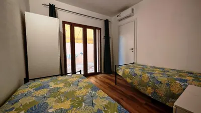 Letto o letti in una camera di Villa Paola San Teodoro con piscina privata