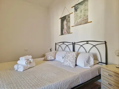 Letto o letti in una camera di Le Melodie - Appartamenti con spazi esterni privati a Sos Alinos