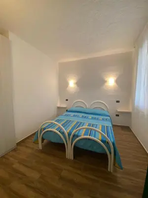 Letto o letti in una camera di Bilo Vista Mare Agrustos