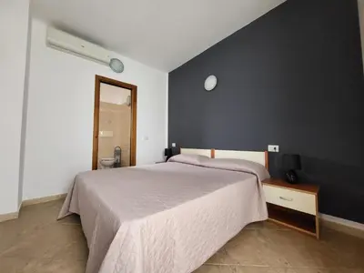 Letto o letti in una camera di White Sand affittacamere