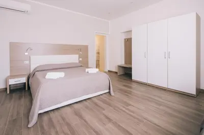 Letto o letti in una camera di La Promenade Rooms & Suites