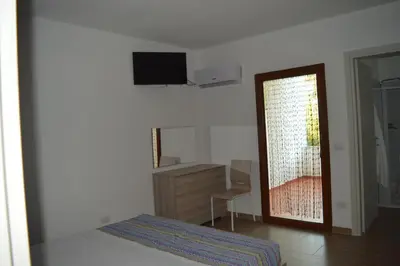 Letto o letti in una camera di Affittacamere Sos Ninnitteddos