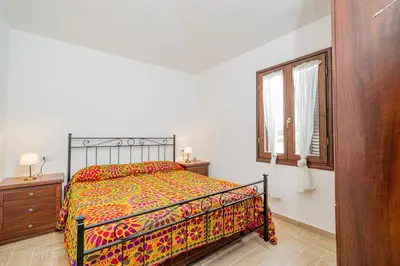 Letto o letti in una camera di Appartamento Trilocale Le Canne 4 posti letto con giardino e posto auto privato