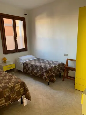 Letto o letti in una camera di Holiday House Olbia Downtown (giardino e ingresso indipendente)