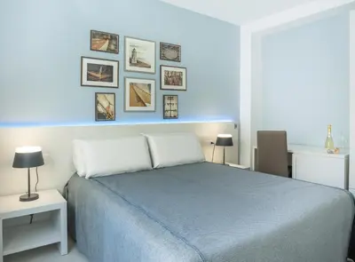 Letto o letti in una camera di J Rooms