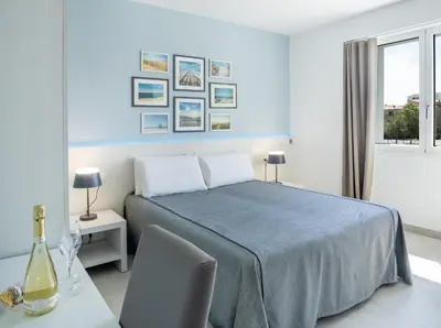 Letto o letti in una camera di J Rooms