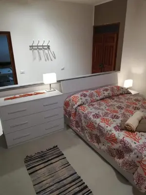 Letto o letti in una camera di APPARTAMENTO CORALLO with PRIVATE GARDEN
