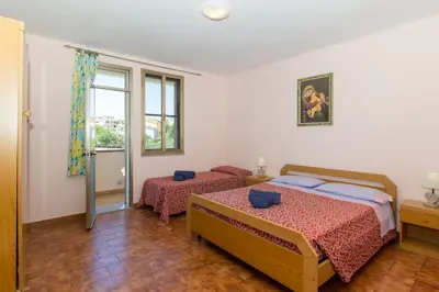 Letto o letti in una camera di Appartamenti in Villa con ampio giardino esterno