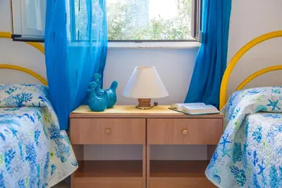 Letto o letti in una camera di Lungomare Bay, e sei in spiaggia...