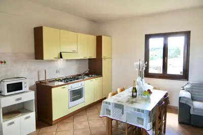 Cucina o angolo cottura di ISS Travel, La Ginestra - 2-bedroom apartment with terrace and view over Tavolara Island