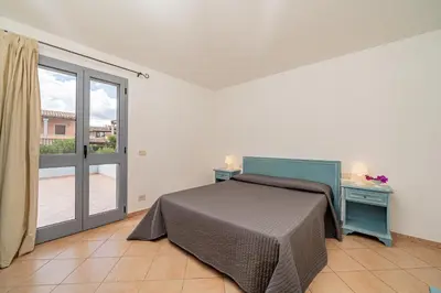 Letto o letti in una camera di Apartments in Residence with swimming pool in Cala Girgolu