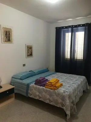 Letto o letti in una camera di casa Alessia