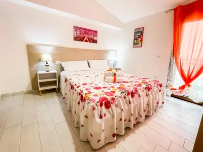 Letto o letti in una camera di B&B FLOWERS