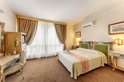 Letto o letti in una camera di Colonna Palace Hotel Mediterraneo