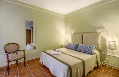 Letto o letti in una camera di Colonna Palace Hotel Mediterraneo