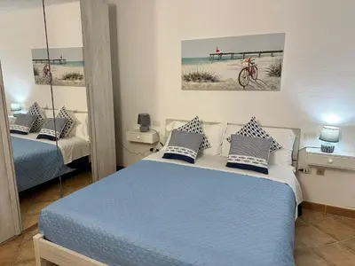 Letto o letti in una camera di Insardinia House trilocale a 200mt dalla spiaggia