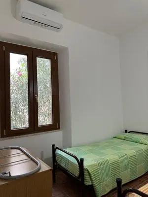 Letto o letti in una camera di Gli ulivi -Appartamento al centro