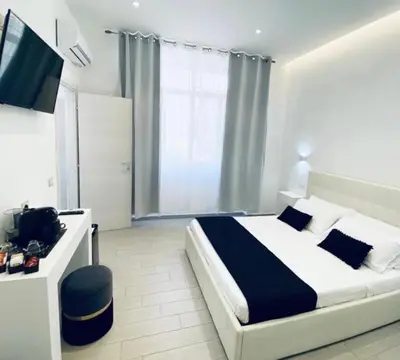 Letto o letti in una camera di International House Olbia
