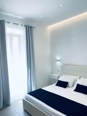 Letto o letti in una camera di International House Olbia