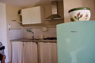 Cucina o angolo cottura di Villa con Splendido Giardino e Vista Mare a Osseddu - Olbia