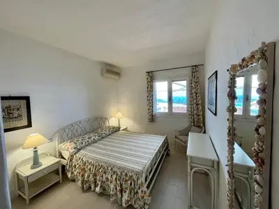 Letto o letti in una camera di SAN TEODORO PUNTA EST STUPENDO TRILOCALE VISTA MARE