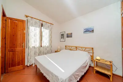 Letto o letti in una camera di Villetta Cala D'Ambra