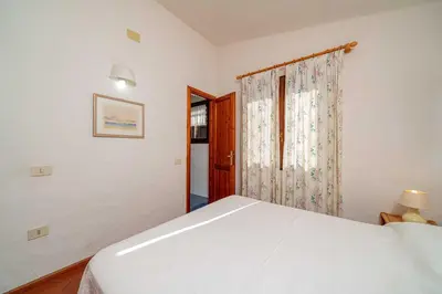 Letto o letti in una camera di Villetta Cala D'Ambra