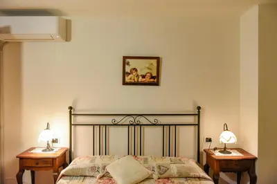 Letto o letti in una camera di Appartamento Mughetto con A/C