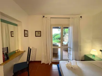 Letto o letti in una camera di SAN TEODORO PUNTA EST SPETTACOLARE QUADRILOCALE VISTA MARE