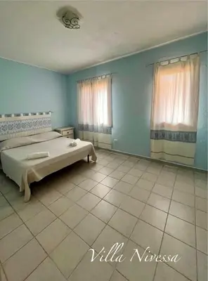 Letto o letti in una camera di Villa Nivessa