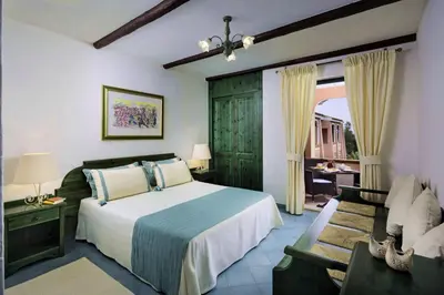 Letto o letti in una camera di Villaggio Cala Ginepro Resort & SPA