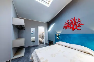 Letto o letti in una camera di RELAIS IL CORALLO
