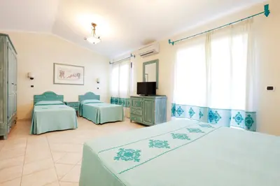 Letto o letti in una camera di Hotel Baia Aranzos