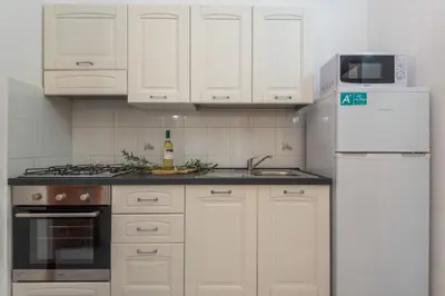 Cucina o angolo cottura di Residenze Gallura Trilo 6 - Happy Rentals