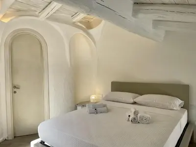 Letto o letti in una camera di SAN TEODORO PUNTA EST FANTASTICO TRILOCALE VISTA MARE
