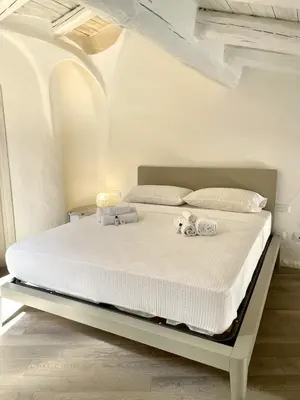 Letto o letti in una camera di SAN TEODORO PUNTA EST FANTASTICO TRILOCALE VISTA MARE