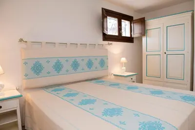 Letto o letti in una camera di Villa Dalia Punta Molara San Teodoro