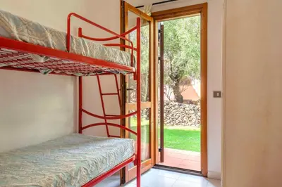Letto o letti in una camera di Apartments in San Teodoro 43450