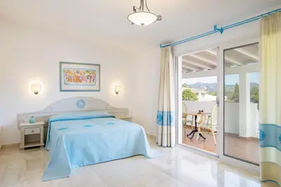 Letto o letti in una camera di Nicolaus Club Quattro Lune Resort